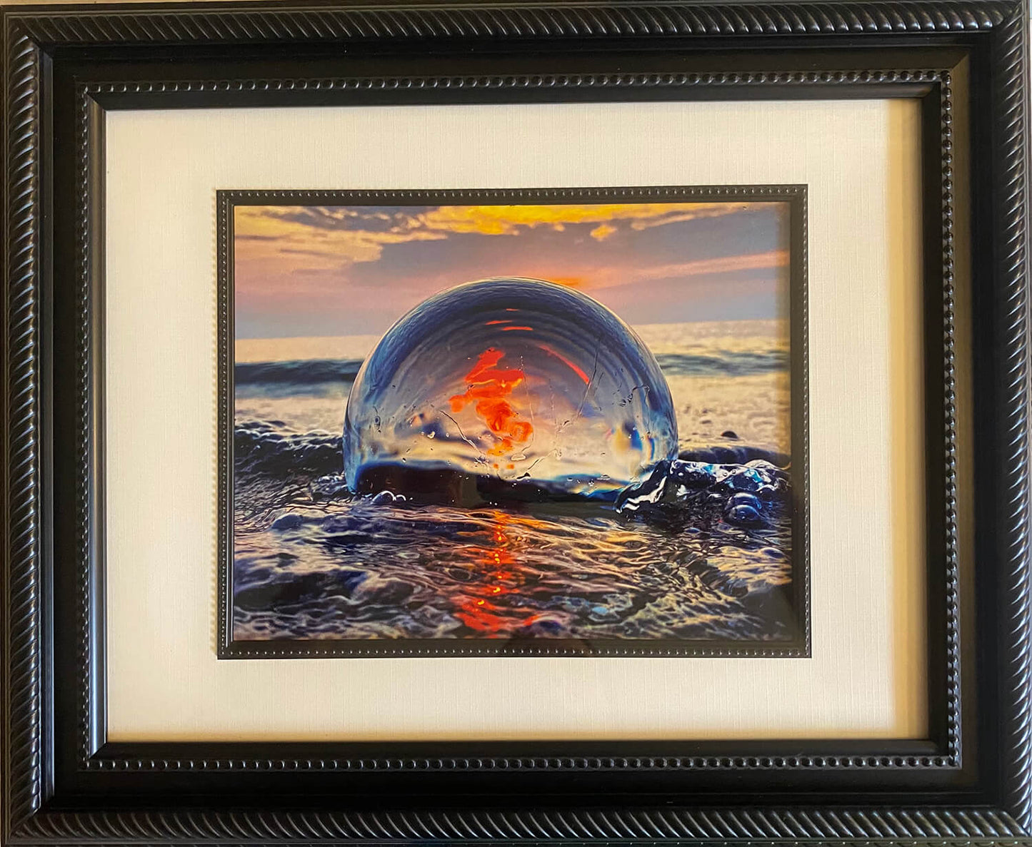 Crystal Ball reflecting the sunset in water photograph in black frame with white inlay