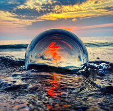 Load image into Gallery viewer, Crystal Ball reflecting the sunset in water