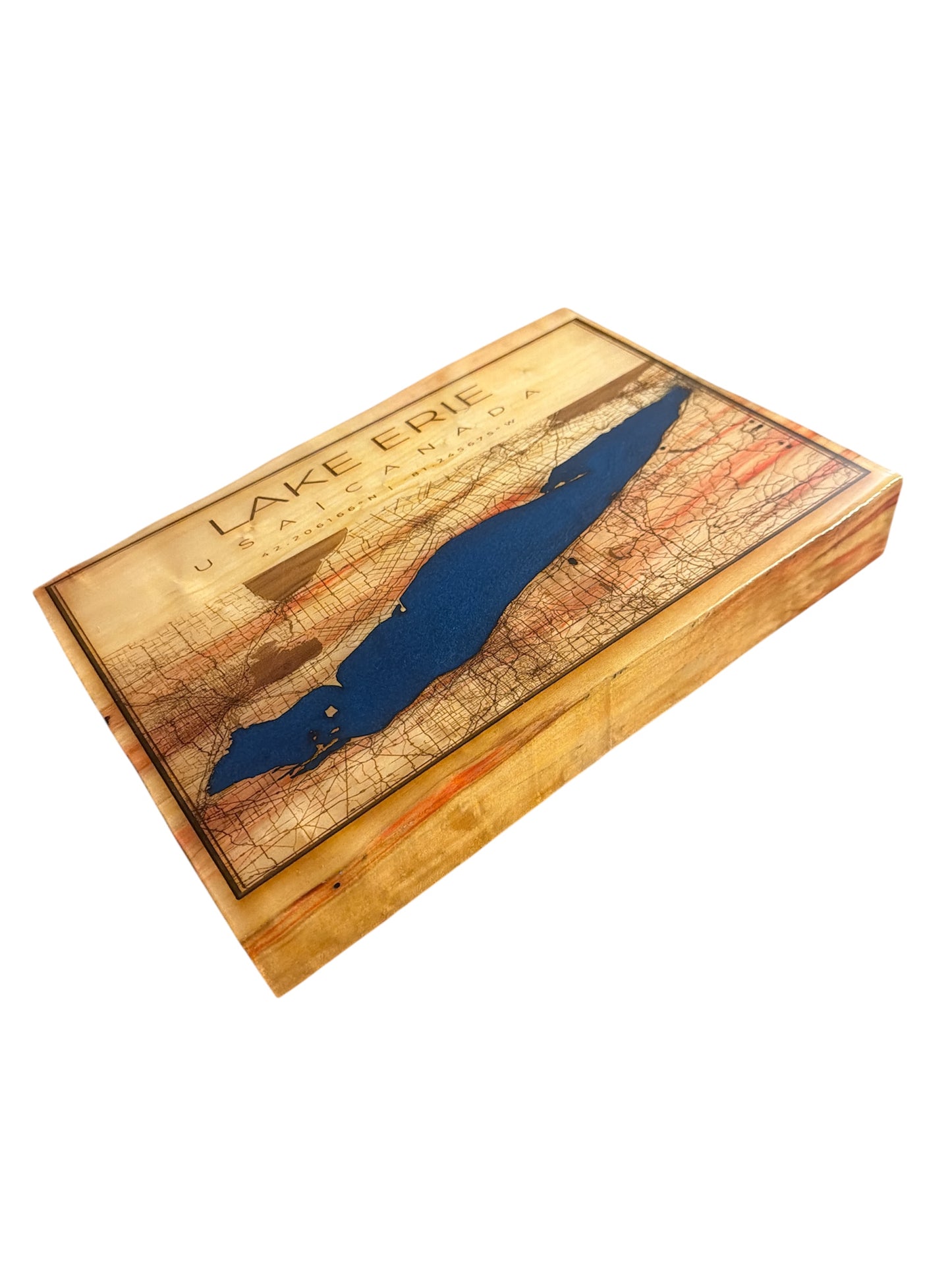 Close-up of precision-engraved Lake Erie coordinates and topographic lines on live edge wood