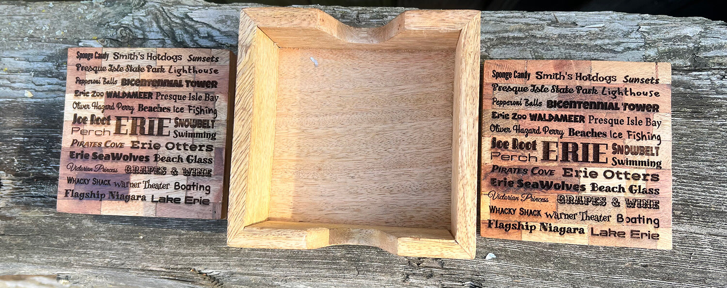 Two Erie themed wooden coasters with a wooden coaster holder in the middle