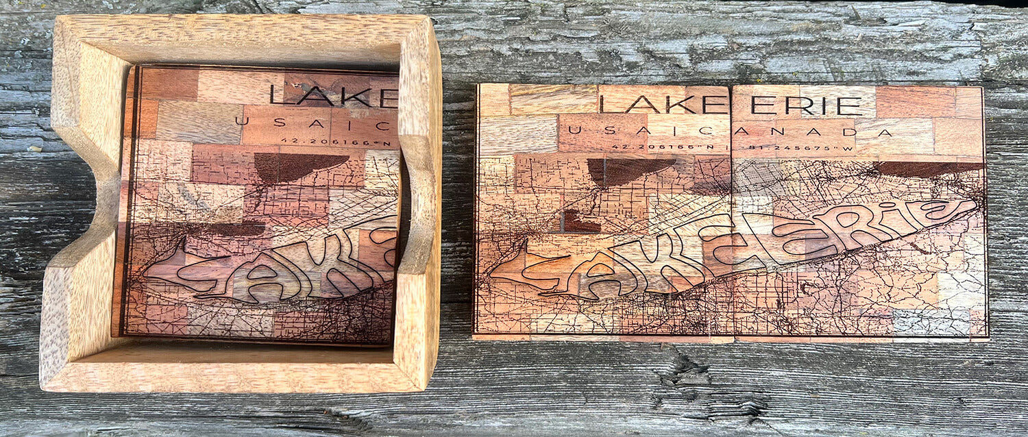 Two connecting Lake Erie map wooden coasters with a wooden coaster holder on the left