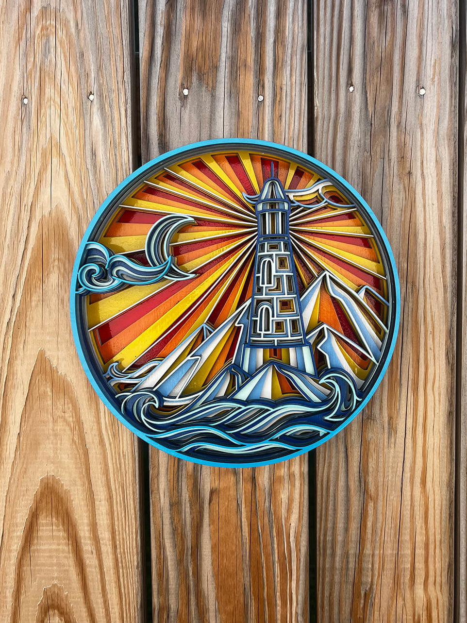Decorative wood wall art with a lighthouse mosaic design on a wooden panel