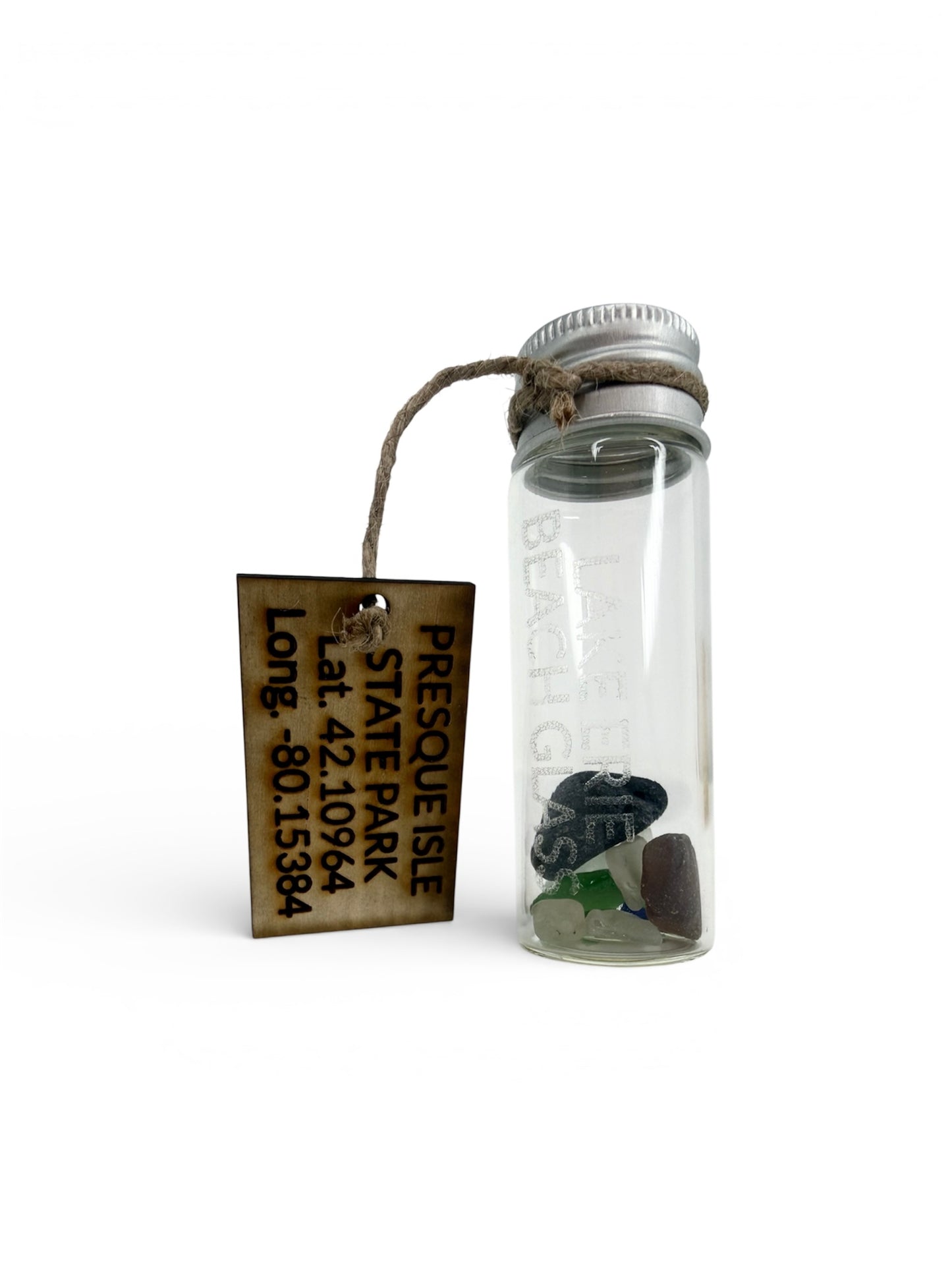 A small glass vial filled with authentic Lake Erie beach glass, featuring a laser-etched "Lake Erie Beach Glass" label and a wooden tag with Presque Isle State Park coordinates.