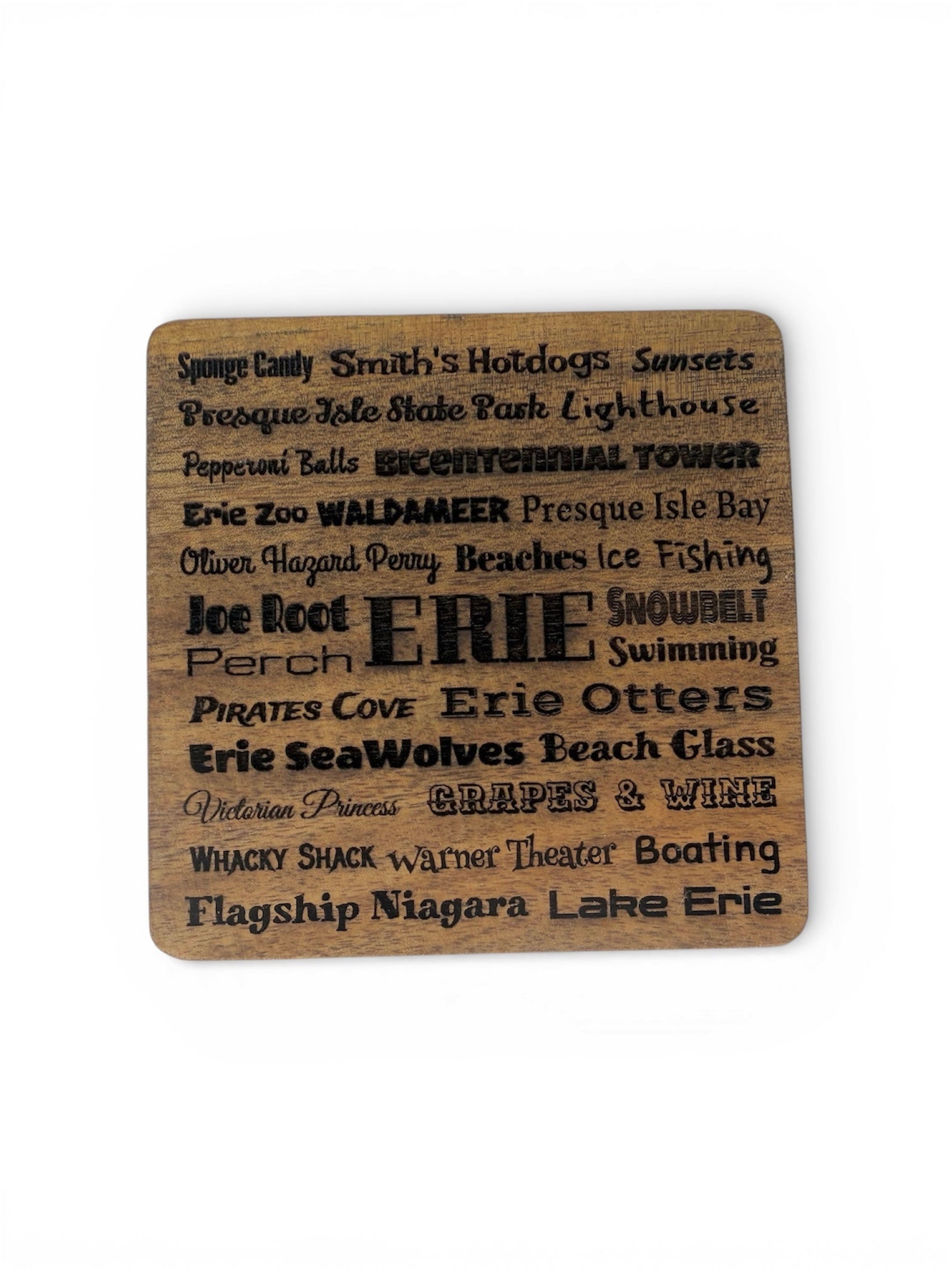 Square wood coaster with laser-engraved typography featuring iconic Erie, PA landmarks and local favorites including Waldameer, Presque Isle, and Smith's Hotdogs.